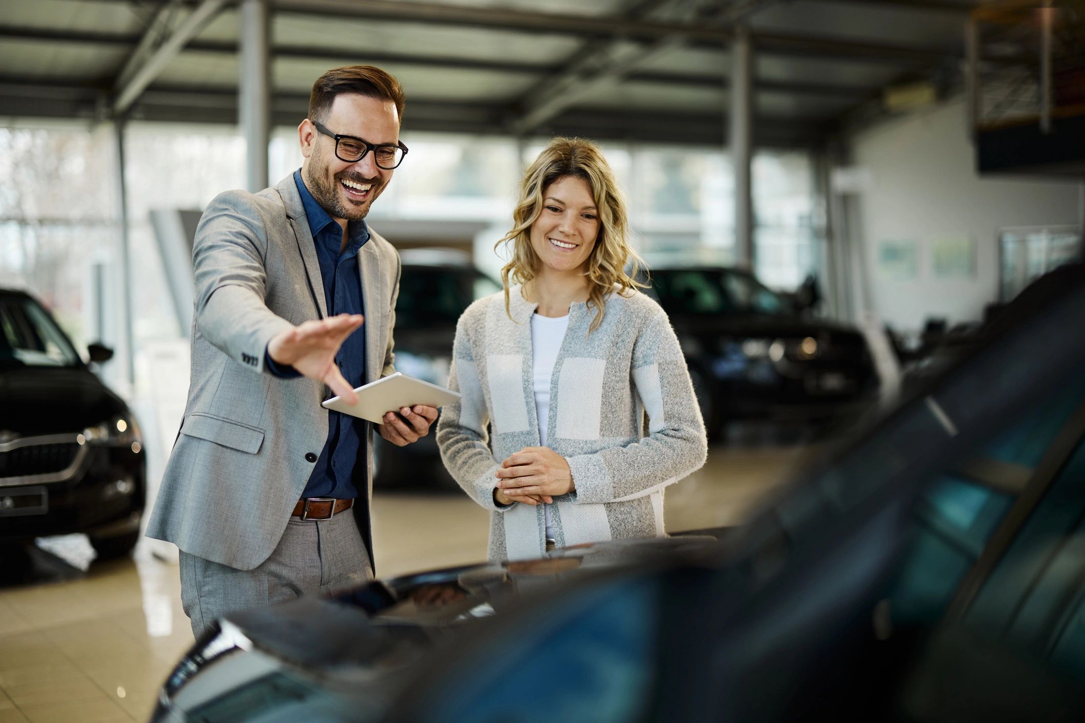 Customer and staff member at vehicle pickup