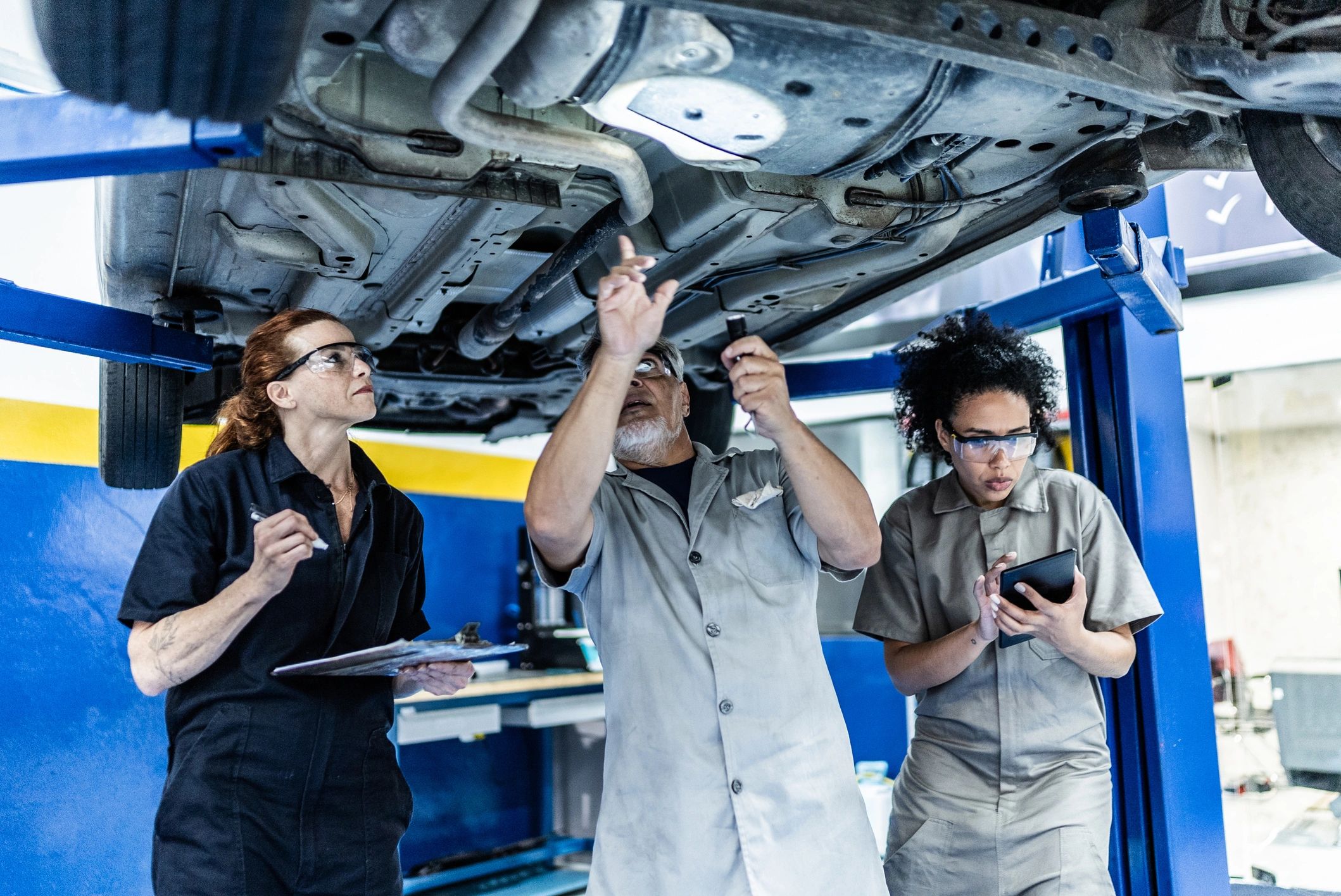 Mechanics working together in a clean auto repair shop