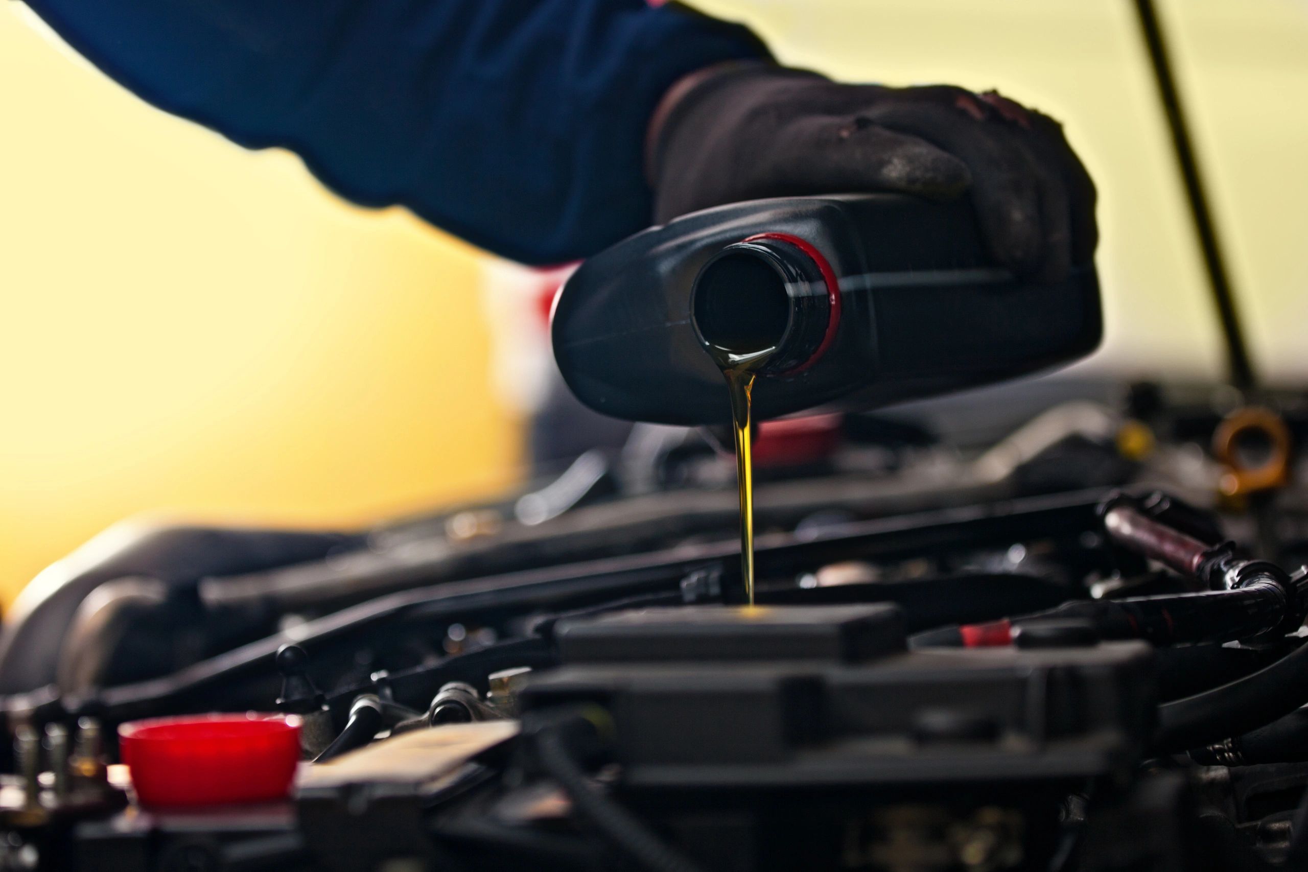 Technician performing an oil change during routine maintenance