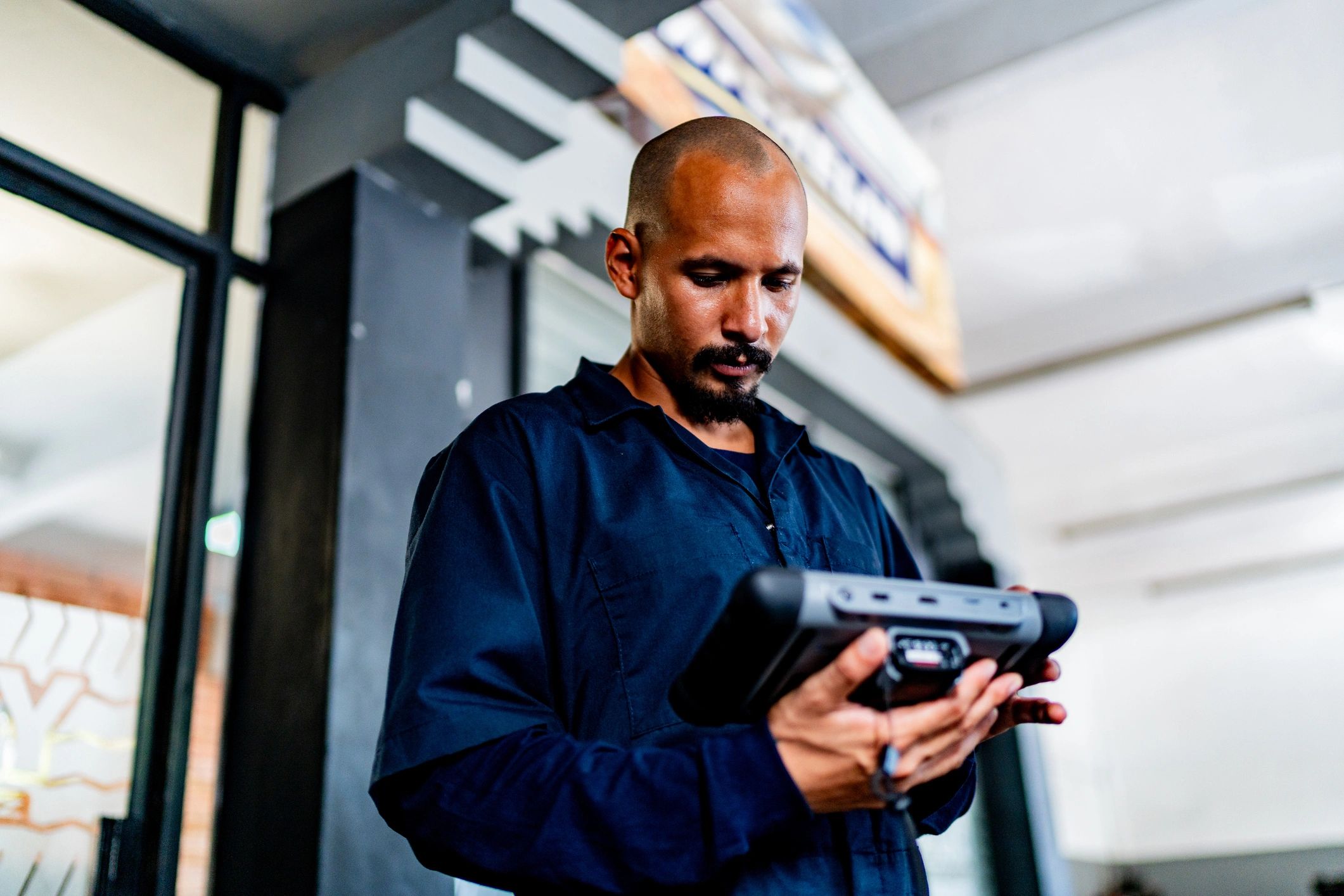 Mechanic performing vehicle diagnostics with a scan tool