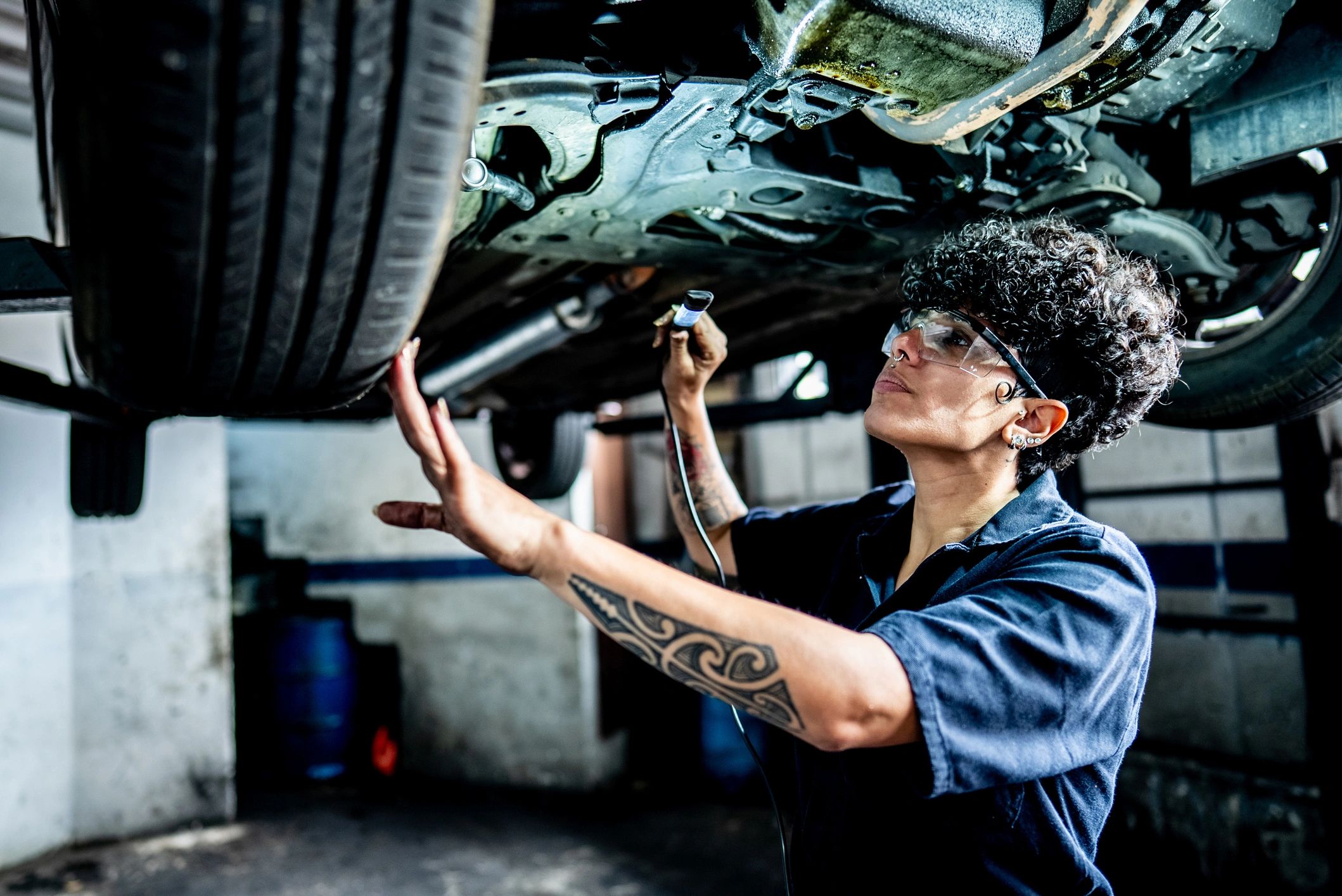 Technician inspecting a vehicle braking system